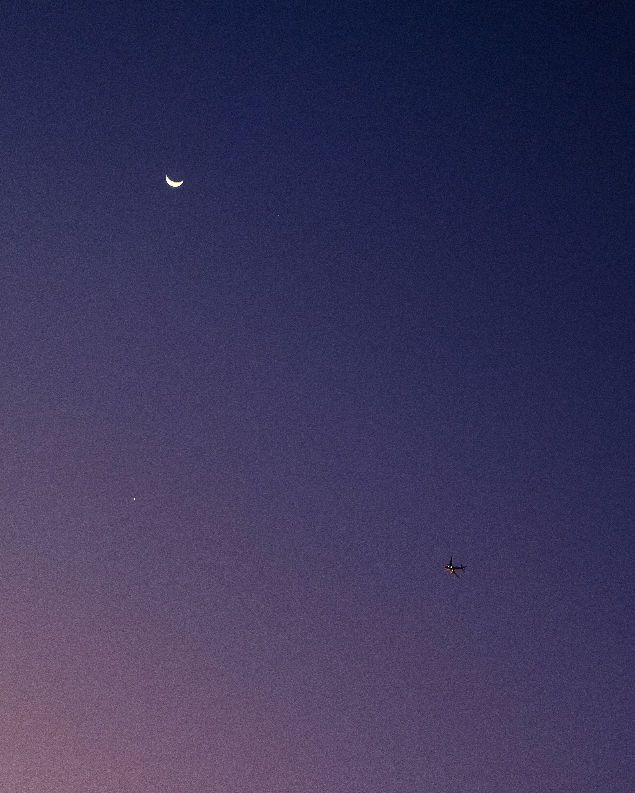 Night sky with plane and moon
